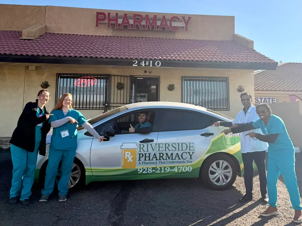 Riverside Pharmacy team with the pharmacy delivery car outside the store
